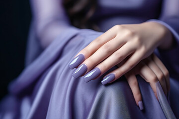 Woman hand with lavender color nail polish on her fingernails. Purple nail manicure with gel polish at luxury beauty salon. Nail art and design. Female hand model. French manicure.