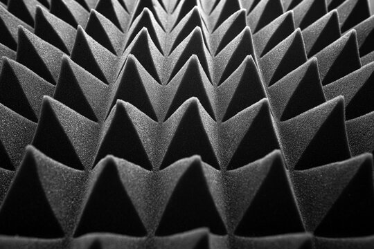 Black pyramids as an abstract background. Acoustic foam.