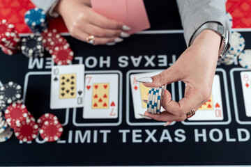  lucky woman playing poker at casino and increases the stakes, the risk for a big win