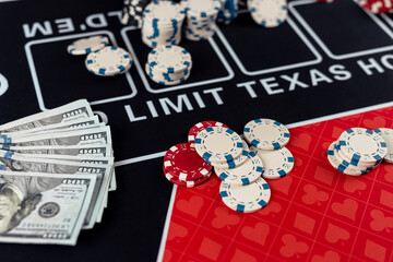  poker chips with playing cards on casino desk