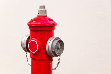 Fire hydrant for two hoses on a white wall background.