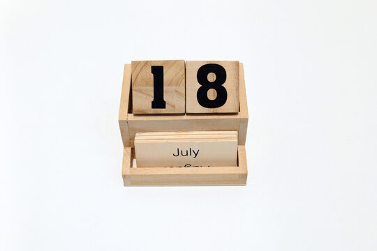 18th of July wooden perpetual calendar. Shot close up isolated on a white background