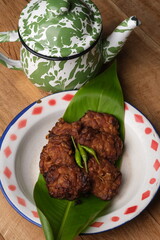 white pepper in the wooden bowl. pepper is a flowering vine in the family Piperaceae, cultivated for its fruit, which is usually dried and used as a spice and seasoning. Piper nigrum. 