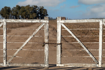 an old wooden fence in the middle of the desert is locked