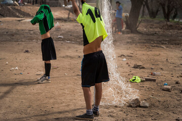 kids taking off their shirts after the soccer game