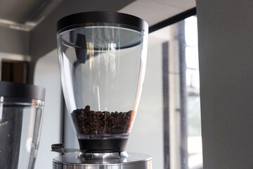 grinder coffee machine. Coffee beans inside the machine hopper of coffee shop