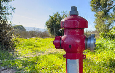 Fire fighting public system. Fire hydrant hose connection red color in Greece. Safety in extinguish.