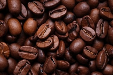 Obraz premium Coffee background. Coffee beans close-up, top view. Coffee texture. Ingredient for preparing a flavored drink. Dark background for design