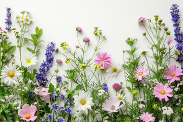 Obraz na płótnie Canvas A vibrant assortment of flowers arranged in a bunch, positioned alongside a wall.