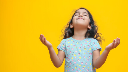 Portrait of a little happy girl on a yellow background. - obrazy, fototapety, plakaty