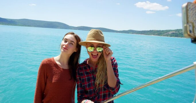 Selfie stick, travel and picture with friends at sea for social media, memory and explore. Summer, adventure and vacation with women and smile at france beach for holiday, spring break and tourism