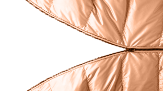 Open dark metal zipper on winter down jacket in trendy color 2024 Peach Fuzz. Detail of trendy metal color jacket with open zipper isolated on white