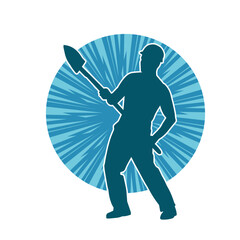 Silhouette of a worker carrying shovel tool. Silhouette of a worker in action pose using shovel tool.