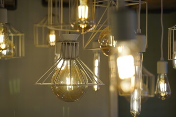 Antique style light bulbs hanging from the ceiling - obrazy, fototapety, plakaty