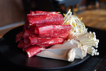 Raw red meat for shabu-shabu is thinly sliced and rolled into a round shape.