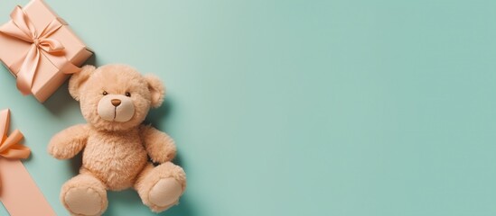 Teddy bear on pastel turquoise background. Flat lay, top view.