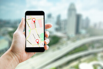 Man hand holding smartphone with GPS Map to Route Destination network connection. Location Street Map with GPS Icons Navigation and Red icon of location. Online Navigation Concept.