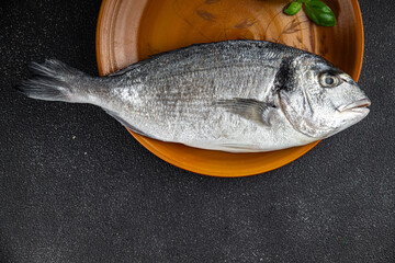 sea bream fish raw seafood tasty fresh healthy eating cooking appetizer meal food snack on the table copy space food background rustic keto or paleo diet Pescetarian