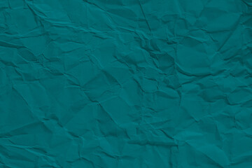 Obraz premium A textured teal paper background with a crumpled surface