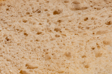 Macro closeup of a slice of loaf of freshly baked sourdough bread