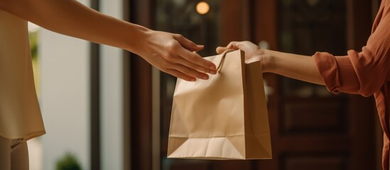A courier gave a paper bag containing food to the woman in front of the house