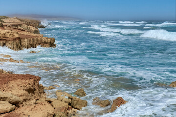 Fototapeta na wymiar Wild coast of Boa Vista island : waves crashing on rocks. Cape Verde.