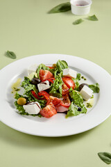 Classic Greek Salad with Feta Cheese and Fresh Vegetables on White Plate