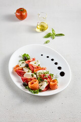 Salmon and mozzarella Caprese salad with fresh tomatoes, top view. Ideal for culinary magazines and healthy eating blogs