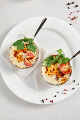 Gourmet julienne with cheese and mushrooms in a white plate, elegantly served with a top view and copy space for menus and culinary guides