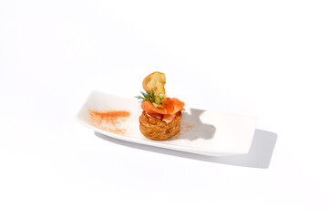 Elegant salmon profiterole garnished with dill on a minimalist white plate, ideal for gourmet...