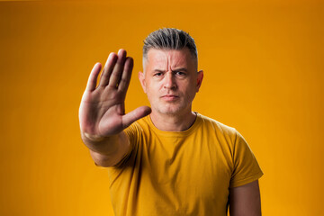 Man showing stop gesture. People and emotion concept