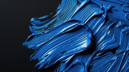 thick blue oil paint on dark black background with brush strokes