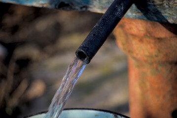 Clean water flows from a plastic pipe