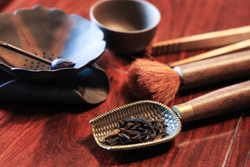 Closeup of oriental tea making ceremony tools: tea spoon, tea brush, tea twezzers, tea cup, tea...