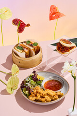 Artistic culinary presentation of a katsu sando in a bamboo steamer, with chicken tempura strips and dipping sauce on a modern minimalist table setting, adorned with vibrant anthurium flowers