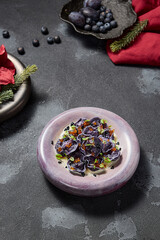 Black Dumplings or Ravioli with Seafood and Caviar in an Elegant Style, Aesthetic Winter Menu