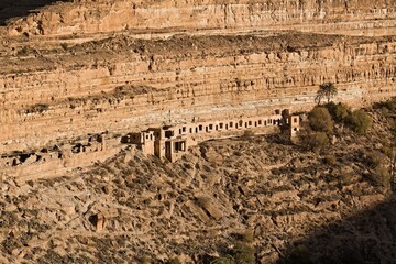 View of ancient cave dwellings in Ghoufi village by the Ighzer Amellal river. Algeria. Africa.