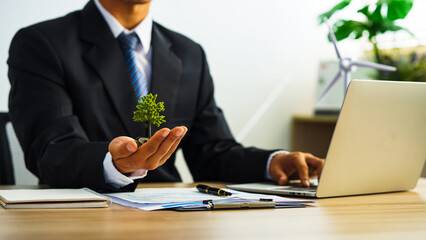 Windmill Concepts. Environmental, Social and Corporate Governance. Businessman Working on Table. Sustainable Resources. Environmental and Business Growth Together.