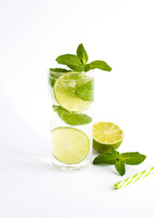 Mojito cocktail in the drinking glass on the white background. Close-up.