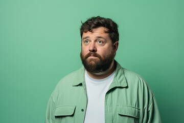 Fototapeta premium Portrait of a man with a beard on a green background