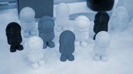 Art object model of astronaut printed on 3D printer. Toy created by 3D printing from molten plastic. Example of creating prototype by 3D printer. Concept 3D printing. 3D printing innovation technology © mari1408