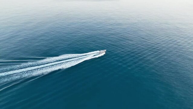 The speed boat on the sea at sunset time.
