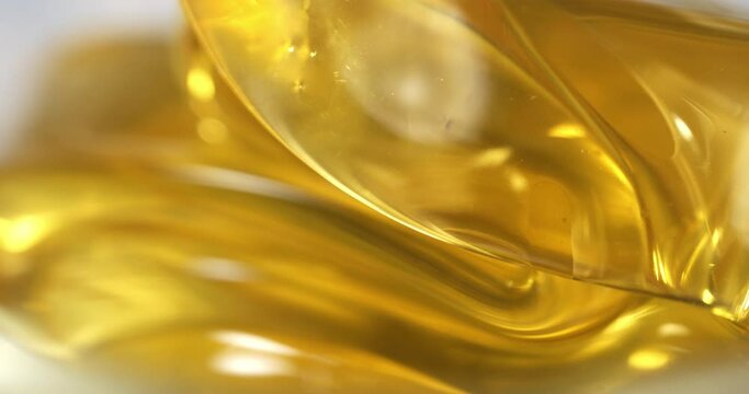 Super slow motion macro of bio organic golden sticky liquid honey is flowing and dripping at 1000 fps.