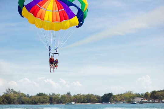 Kids parasailing. Water sport on summer vacation.