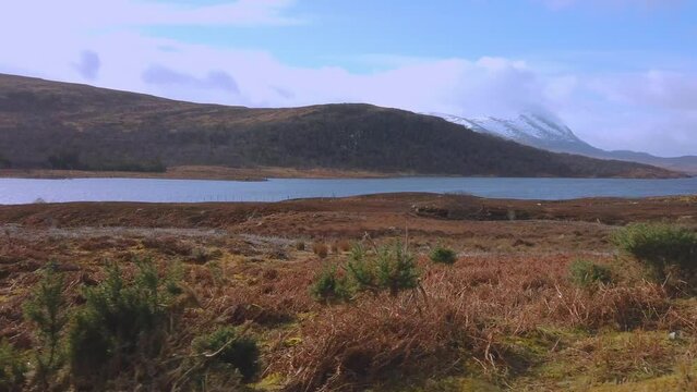 Car point of view, POV driving along a landscape and scenery through beautiful roads in the Scottish highland.