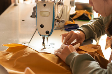 Female hands sewing with modern sewing machine at work Sewing process, upholstery, clothing, DIY...