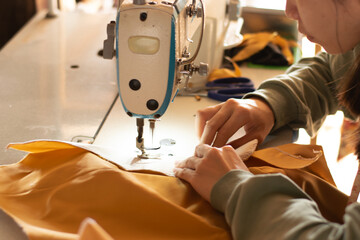 The lady who sews by hand uses modern sewing machinery to sew, DIY repair technology, hand-making,...