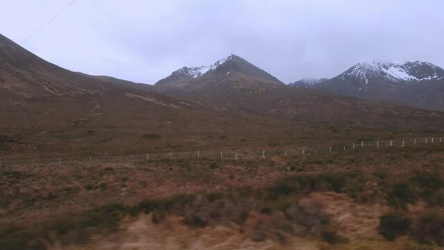 Car point of view, POV driving along a landscape and scenery through beautiful roads in the Scottish highland.