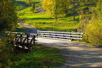 Wooden bridge across mountain creek in Biala Woda nature reserve in autumn, Pieniny, Poland.