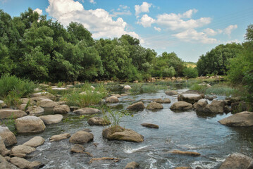 river with large stones on a sunny summer day. big stones on the river